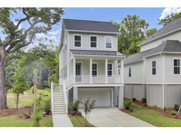 Charming two-story home featuring a welcoming front porch and a convenient drive-under garage at 615 Du Bois Dr, Johns Island, SC 29455