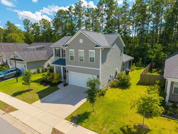 Beautiful two-story home with a well-manicured lawn, attached garage, and inviting curb appeal at 704 Kilarney Rd, Summerville, SC 29483