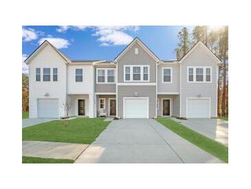 Charming townhomes feature a modern design, attached garages, and well-manicured lawns at 8746 Silver Perch Ln, North Charleston, SC 29420