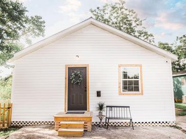 Charming home with white siding, a cozy front porch, and a decorative wreath on the front door at 2157 Jeff St, North Charleston, SC 29405