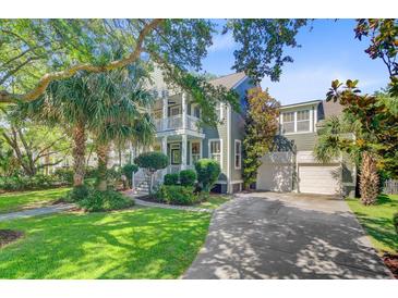 Charming two-story home with a well-manicured lawn, lush landscaping, and a two-car garage at 2228 Daniel Island Dr, Charleston, SC 29492
