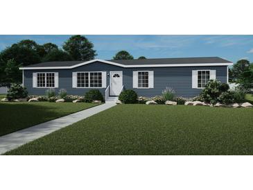 Charming single-story home with blue siding, white trim, a well-manicured lawn, and a paved walkway at 313 Marion Rd, Dorchester, SC 29437