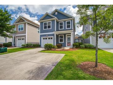 Charming two-story home featuring a well-manicured lawn, driveway, and attached garage at 3903 Poplar Grove Pl, Summerville, SC 29483