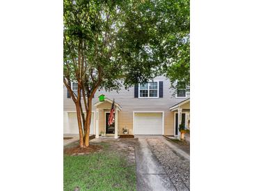 Inviting townhouse exterior with well-maintained siding, attached garage, and manicured lawn, offering great curb appeal at 4030 Babbitt St, Charleston, SC 29414