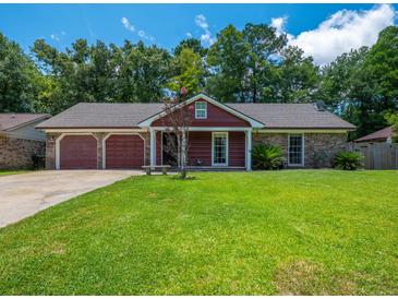 Charming single-story home with a well-maintained lawn, attached garage, and beautiful landscaping at 439 Temple Rd, Ladson, SC 29456