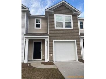 Charming two-story home with a one car garage, neutral siding, and a welcoming entrance at 4669 Palm View Cir, North Charleston, SC 29418