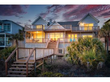 Expansive multi-story home with multiple decks and stairs leading down to the beach at 505 E Arctic Ave, Folly Beach, SC 29439