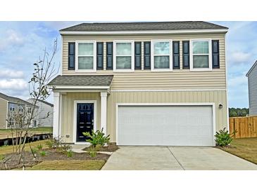 Charming two-story home featuring black shutters, a built-in garage, and manicured landscaping at 549 Pender Woods Dr, Summerville, SC 29486