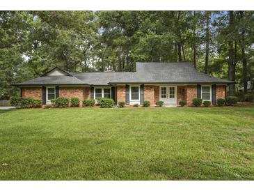 Charming brick home with well-manicured lawn and mature trees offering classic curb appeal at 96 King Charles Cir, Summerville, SC 29485