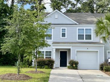 Charming two-story home featuring a well-maintained lawn, attached garage, and classic light-grey siding at 109 Rosefield Ct, Summerville, SC 29485