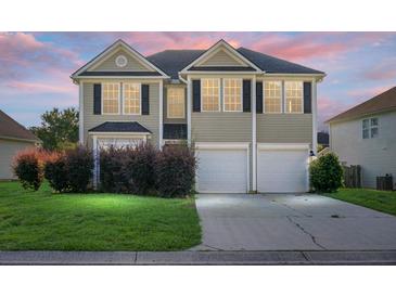 Charming two-story home with a well-maintained lawn, a two-car garage, and neatly trimmed bushes in the front yard at 3013 Argyll Dr, Summerville, SC 29483