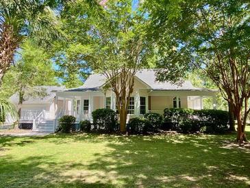 Charming single-story home with lush landscaping and mature trees in a desirable neighborhood at 5079 Coral Reef Dr, Johns Island, SC 29455