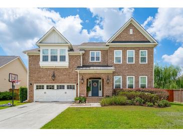 Charming two-story brick home with a well-manicured lawn and a two-car garage at 525 Yellow Tower Ter, Charleston, SC 29412
