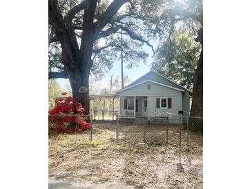 Charming single-story home featuring light blue siding, covered porch, and mature landscaping at 708 Francis St, Walterboro, SC 29488