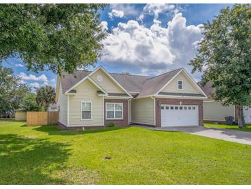 Charming single-Gathering home with manicured lawn and attached two-car garage at 7812 Spring Creek Rd, North Charleston, SC 29418