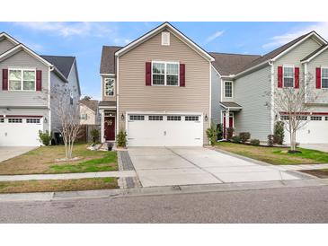 Charming two-story home with a well-manicured lawn, two-car garage and inviting curb appeal at 9009 Cat Tail Pond Rd, Summerville, SC 29485
