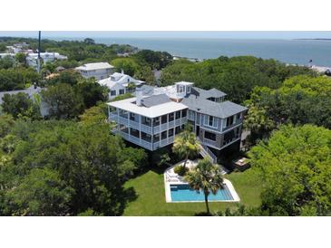 Stunning coastal home with a private pool and lush landscaping, offering an idyllic retreat near the ocean at 932 Middle St, Sullivans Island, SC 29482