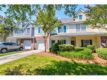 Townhome exterior with beautiful landscaping, driveway and garage at 143 Dorothy Dr, Charleston, SC 29414