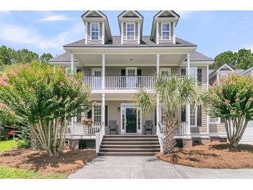 Charming two-story home with a double porch, lush landscaping and a welcoming entrance at 1436 Lagoon Park Cir, Mount Pleasant, SC 29466