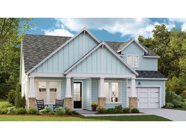 Charming blue two-story home with landscaped yard and inviting front porch at 235 Denham St, Summerville, SC 29486