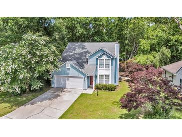 Charming two-story home featuring light blue siding, well-maintained landscaping, and an attached garage at 2773 Forest Dew Ct, Charleston, SC 29414