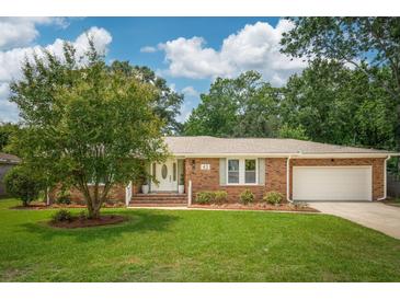 Charming brick home with a well-manicured lawn, mature tree, and an attached two-car garage at 43 Heathwood Dr, Charleston, SC 29407