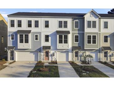 Charming townhome featuring modern architectural details and attached garage at 430 Caledon Court Ct, Johns Island, SC 29455