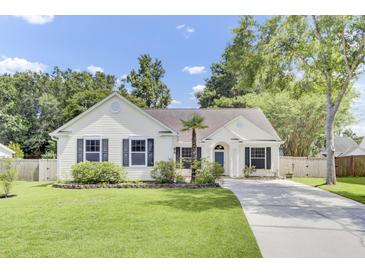 Charming single-story home with a manicured lawn, driveway, and well-maintained landscaping at 5406 Dwight Dr, North Charleston, SC 29420