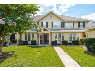 Inviting two-story home with a manicured lawn, charming front porch, and mature landscaping at 5511 Colonial Chatsworth Cir, North Charleston, SC 29418