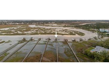 Panoramic aerial view of a home's private dock extending into a scenic marsh, offering waterfront access at 627 Barbados Dr, Charleston, SC 29492