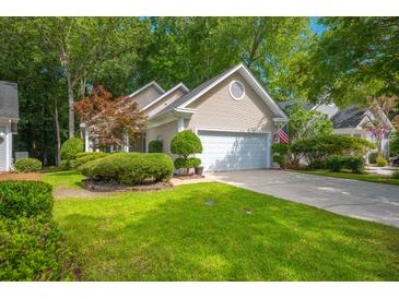 Charming single-Gathering home featuring a two-car garage, mature landscaping, and a well-manicured lawn at 9175 Spring Branch Ct, North Charleston, SC 29406