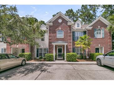 Charming brick townhouse featuring manicured landscaping and a welcoming front entrance at 1682 Camfield Ln, Mount Pleasant, SC 29466