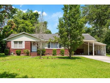 Charming single-story home with brick accents, mature trees, and a covered carport, perfect for comfortable living at 1900 Morgan Ave, North Charleston, SC 29406