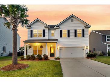 Charming two-story home with manicured lawn, attached garage and beautiful landscaping at 3018 Vincent Astor Dr, Johns Island, SC 29455