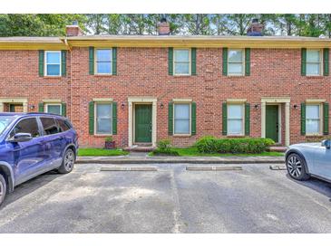 Charming brick townhouse with green shutters and well-maintained landscaping at 302 Springview Ln # 7, Summerville, SC 29485