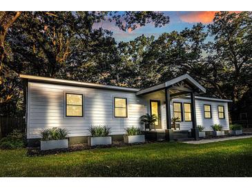 Charming home featuring a well-manicured lawn, stylish planters, and modern black-framed windows at 3435 Hobson Dr, Johns Island, SC 29455