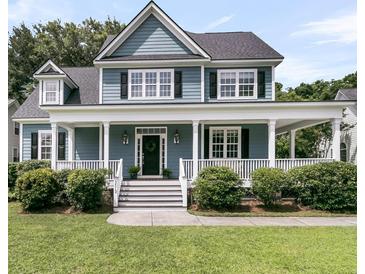 Charming two-story home with a welcoming front porch, beautiful blue siding, and well-maintained landscaping at 3513 Flowering Oak Way, Mount Pleasant, SC 29466