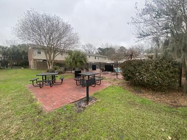 Community pool and picnic area with black tables, grills, and landscaping in a residential community at 415 Parkdale Dr # 6D, Charleston, SC 29414