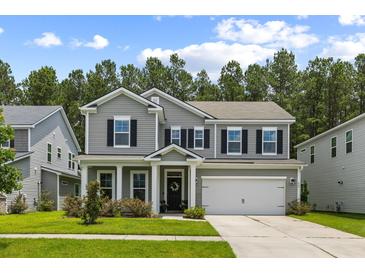 Charming two-story home with gray siding, black shutters, and a well-manicured front lawn at 423 Sanctuary Park Dr, Summerville, SC 29486