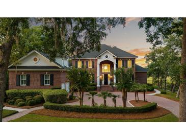 Stately brick home with a circular driveway, manicured landscaping, and a grand entrance at 510 Traders Aly, Mount Pleasant, SC 29464