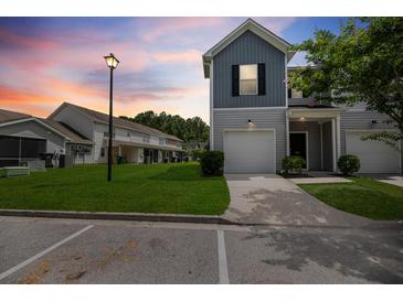 Charming townhome with attached garage and well-maintained lawn at twilight at 540 Truman Dr, Goose Creek, SC 29445