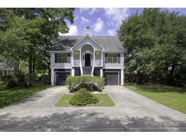 Charming two-story home with symmetrical design, well-maintained landscaping and double garage, offering curb appeal at 633 Stono Edge Dr, Charleston, SC 29412