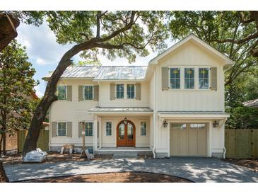 Beautiful two-story home with cream siding, a metal roof, and a spacious garage at 743 Hills St, Mount Pleasant, SC 29464