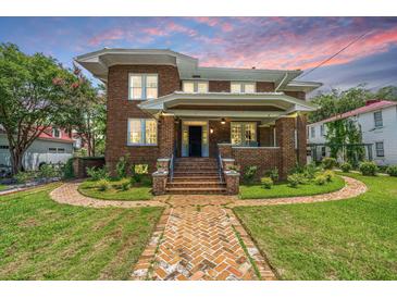 Charming two-story brick home with a welcoming front porch and beautiful brick walkway at 88 Smith St, Charleston, SC 29401