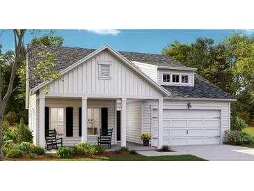 Charming home with a two-car garage, a covered porch, and beautiful landscaping at 1027 Riverbed Retreat Ln, Summerville, SC 29483