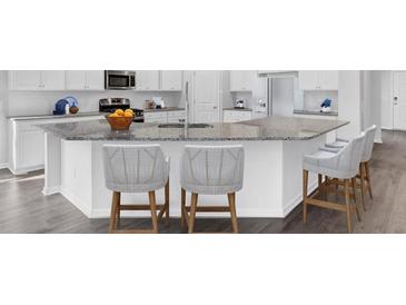 Modern kitchen boasts granite countertops, stainless steel appliances, and bar seating at 109 Orchard Blossom Ln, Summerville, SC 29485