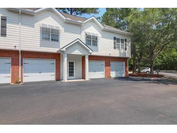 Inviting two-story townhouse featuring attached garages and a manicured lawn at 1604 Basildon Rd, Mount Pleasant, SC 29466