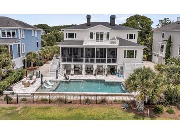 Luxury home featuring a swimming pool, screened in porch and spacious back yard at 1636 Rivertowne Country Club Dr, Mount Pleasant, SC 29466