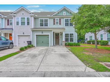 Charming two-story home featuring a green garage door and manicured lawn at 1666 Bridwell Ln, Mount Pleasant, SC 29466