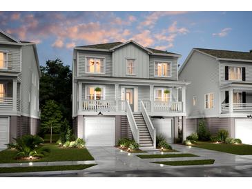 Charming two-story home with a welcoming front porch, a finished garage and manicured landscaping at 1751 Cultivation Lane Dr # 498, Mount Pleasant, SC 29466